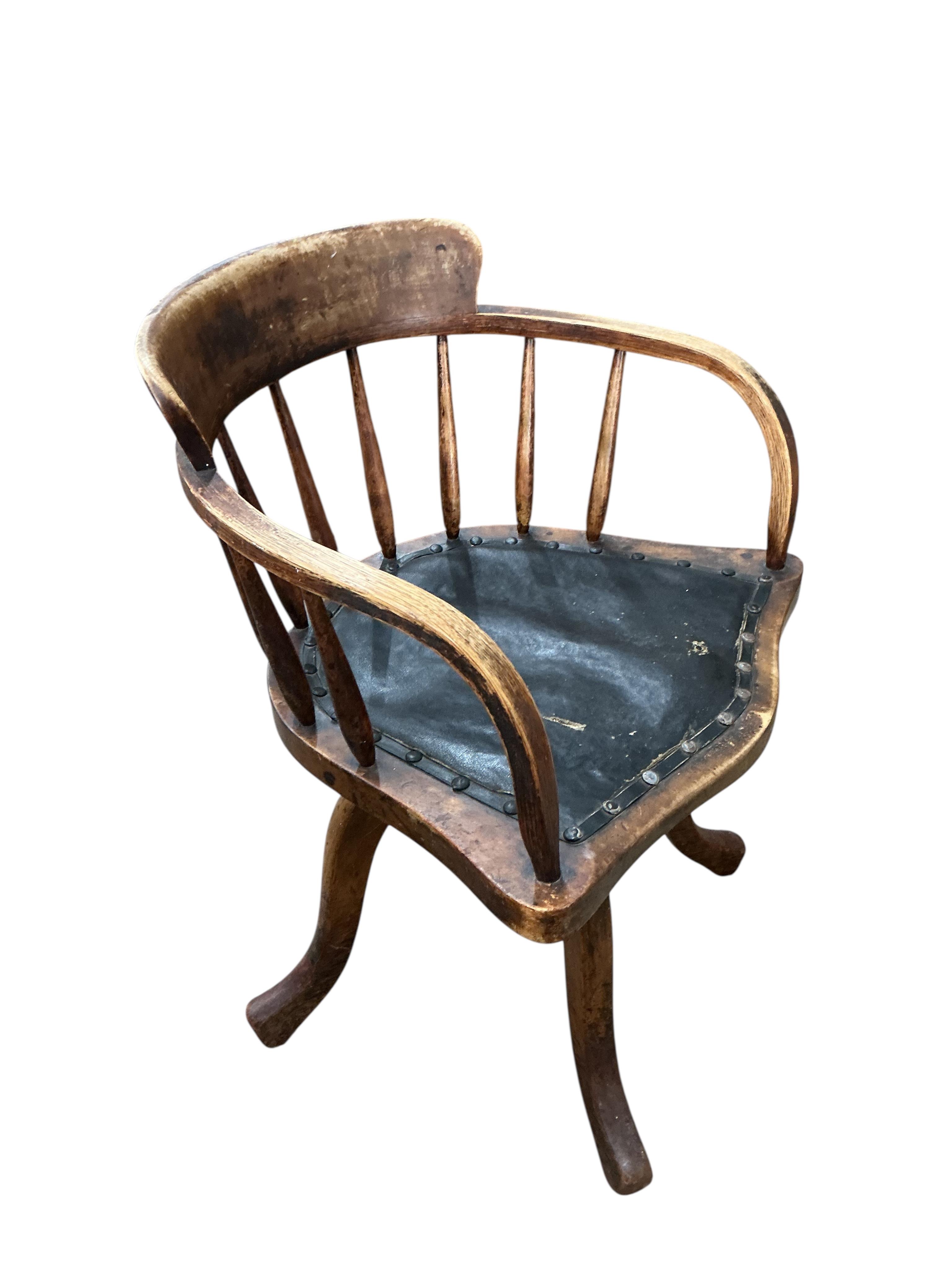 An early 20th century ash and beech revolving desk chair, width 55cm, depth 45cm, height 76cm